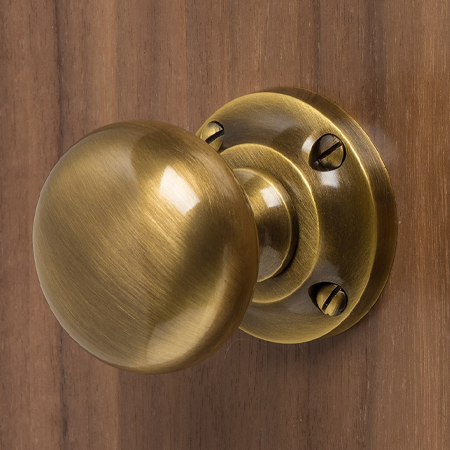 Heritage Brass Brass Door Knobs on a Rose